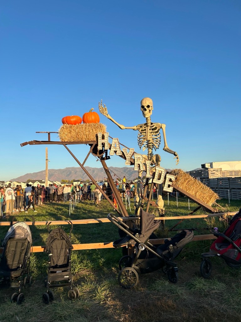 Giant skeleton and hayride sign at Black Island Farms