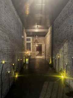 Candlelit brick corridor in New Orleans