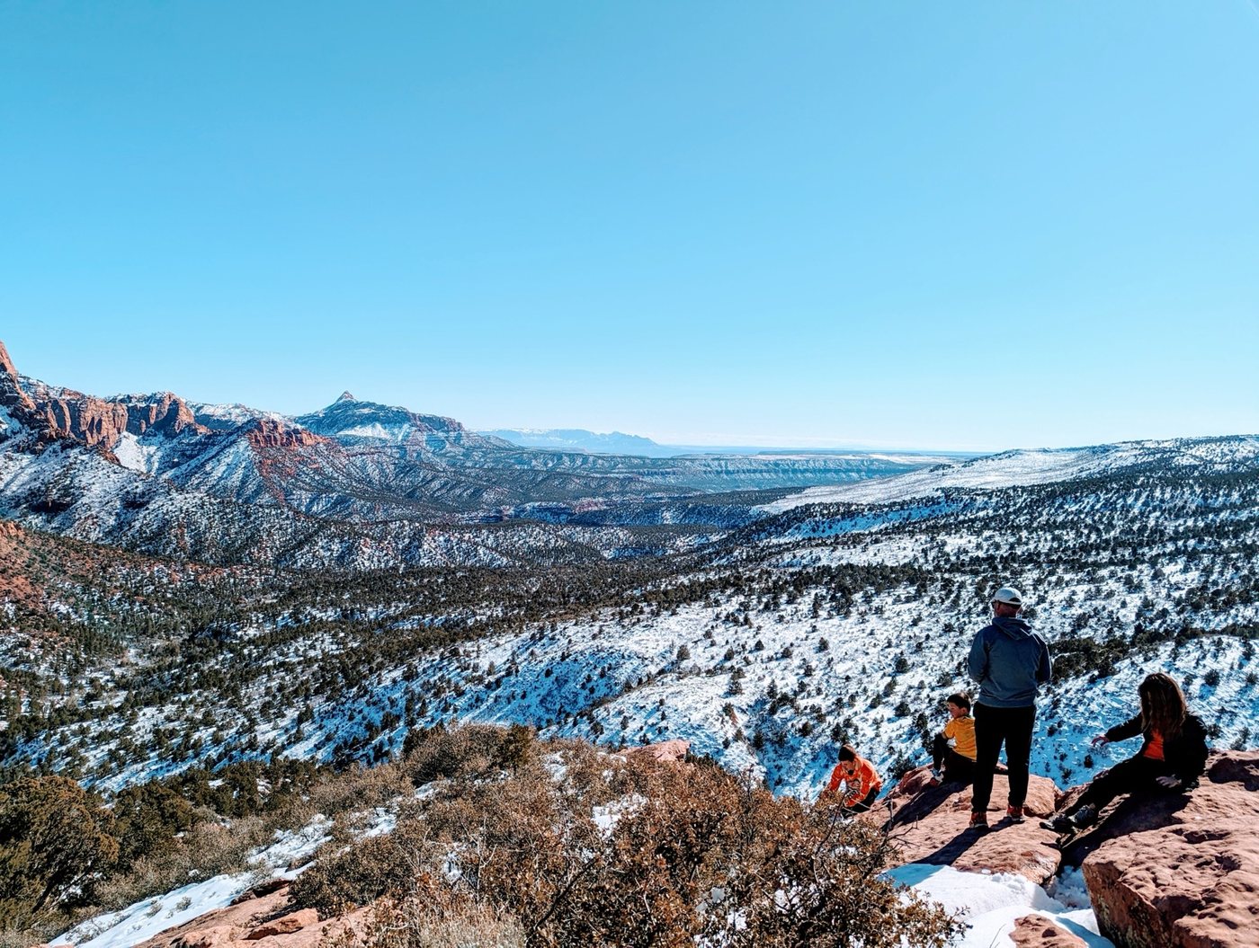 Snow-covered red cliffs and broad valley at Kolob Canyons