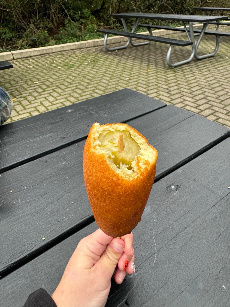 Pickle pup with a bite showing the whole pickle inside