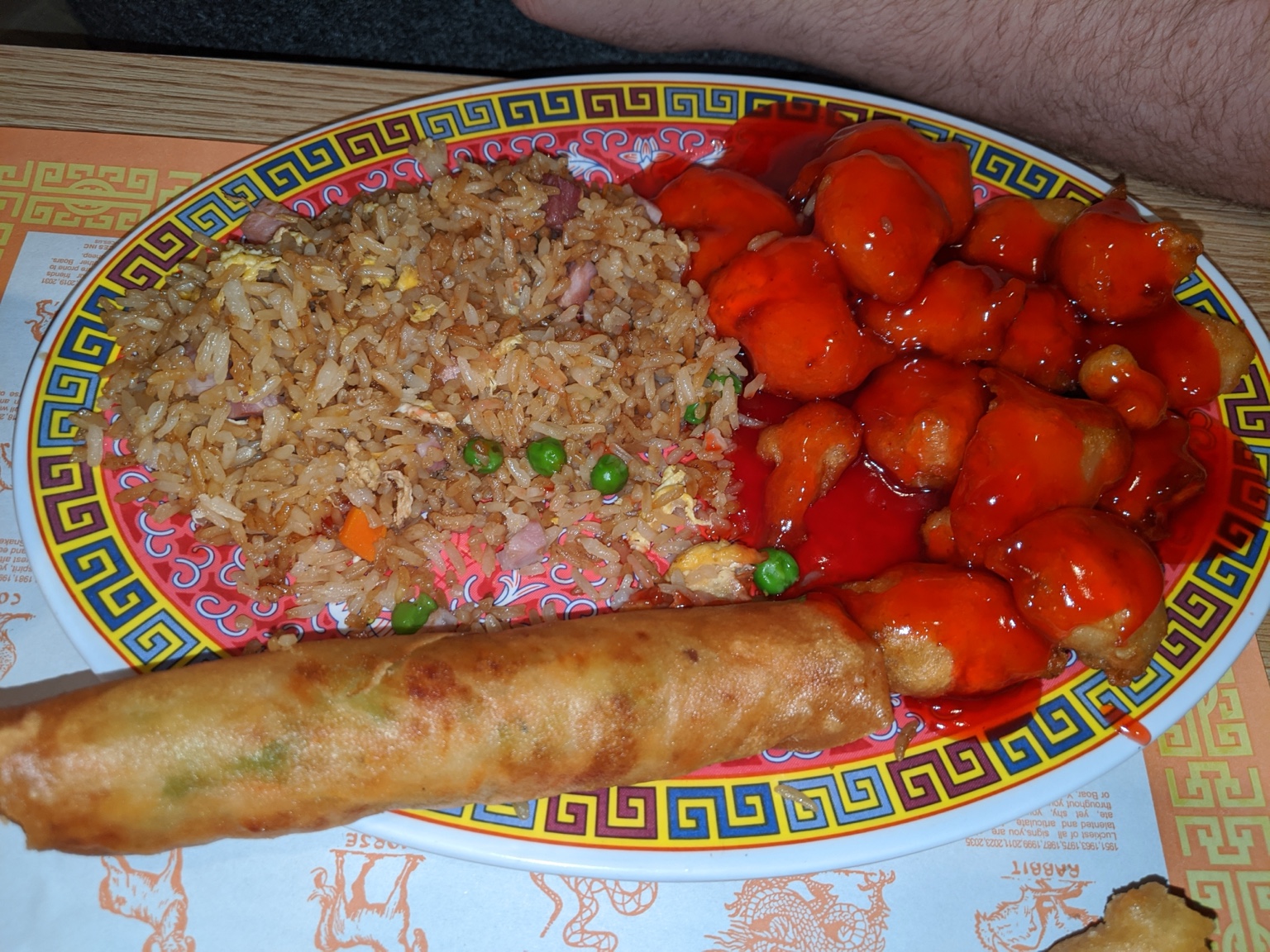Chicken in red sauce with fried rice and an egg roll at La Choi’s