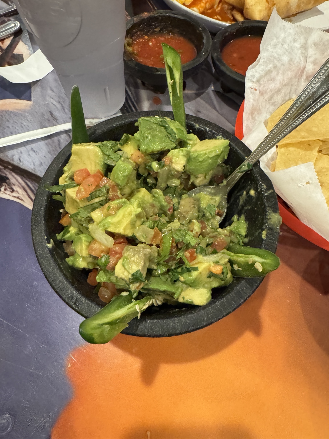 Fresh chunky guacamole with avocado, tomato, cilantro, and jalapenos